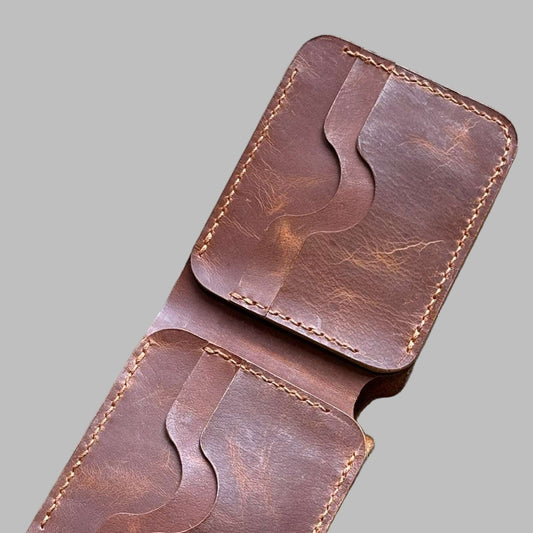 Brown leather wallet on a gray background